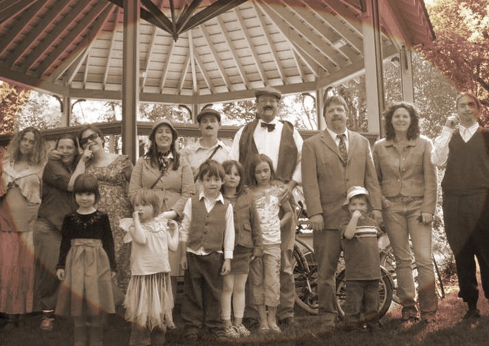 Everyone with a finger over their lip suddenly is in period costume: a mustache!